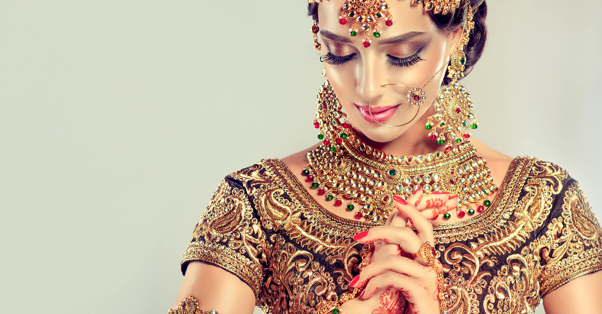 gorgeous indian bride in traditional wedding outfit with colorful jewerly