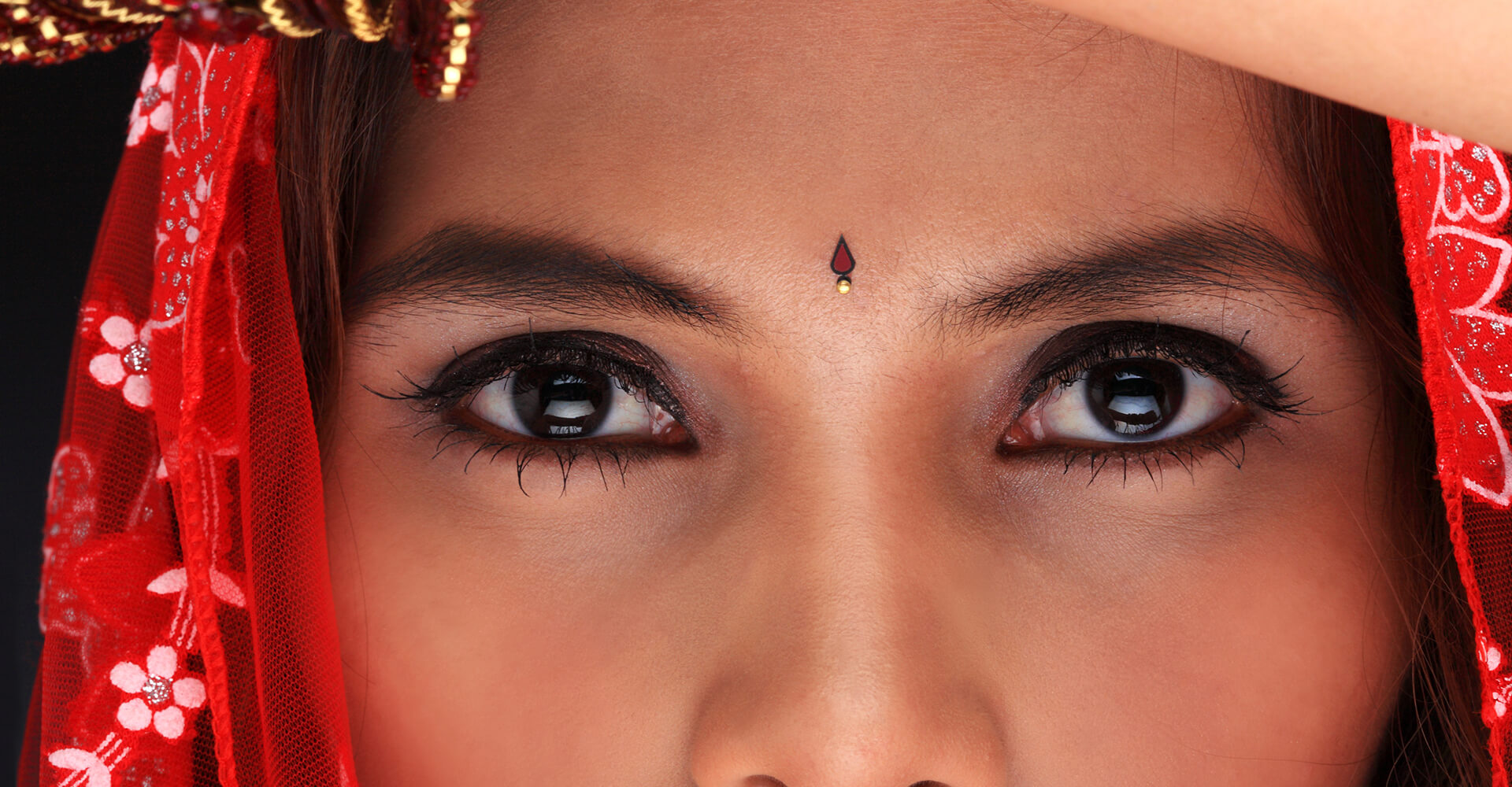 close-up of brown eyes of a beautiful indian bride