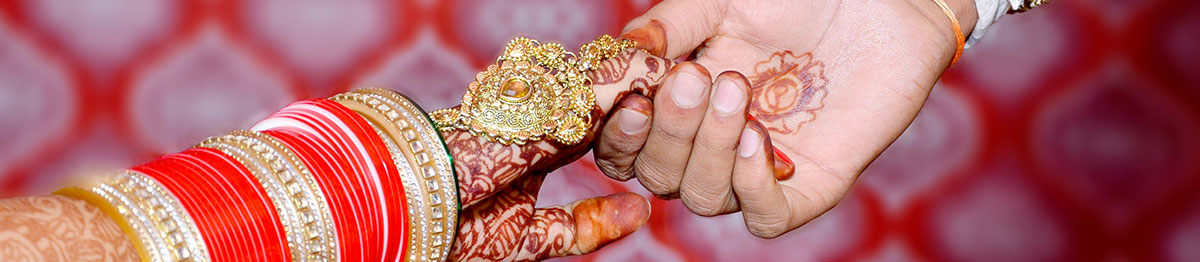 close-up of hands of indian bride and groom at their wedding