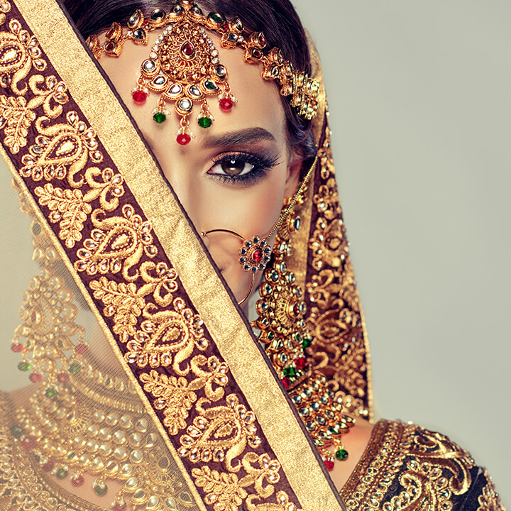 close-up of beautiful indian bride's face in traditional head dress with jewels