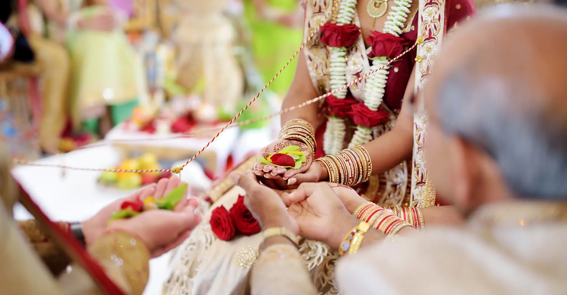 Close up of bride and groom's hands during an Indian wedding ceremany